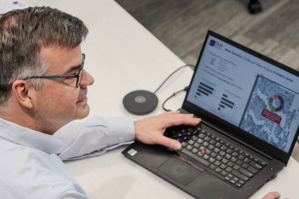 Ricardo listening with open laptop